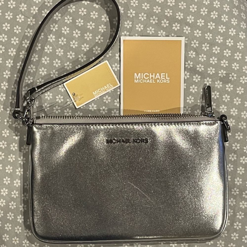 Michael Kors Small Shimmering Silver Pouch Wristlet NWT has scratch